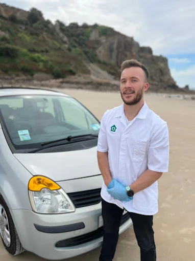 Hugo, founder of Elder Connect, standing beside his car while working as a mobile foot care professional